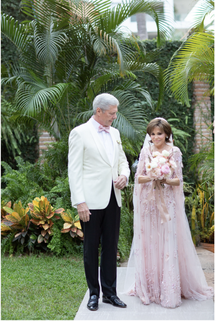 The couple walked down the aisle to the sounds of 'I Can't Help Falling in Love With You.' (Photo by Kara Martinez)